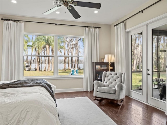 bedroom with multiple windows, access to exterior, and dark hardwood / wood-style flooring