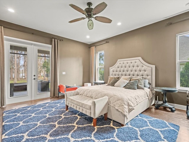 bedroom with access to exterior, wood-type flooring, french doors, and ceiling fan