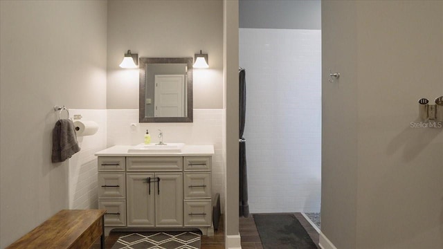 bathroom with tile walls and vanity