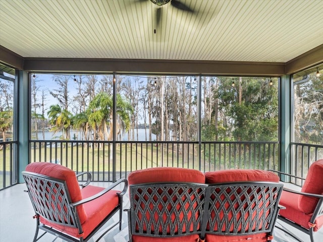 sunroom / solarium with a water view and plenty of natural light