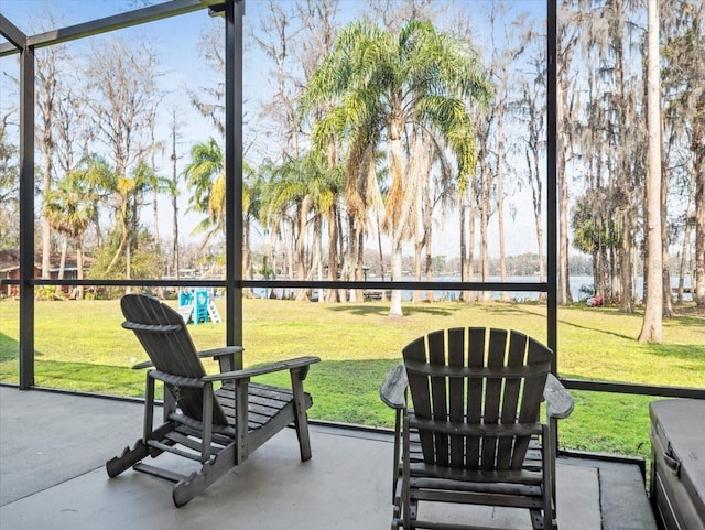 sunroom with a water view and a wealth of natural light