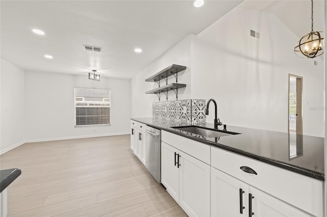 kitchen with sink, light wood-type flooring, dishwasher, pendant lighting, and white cabinets