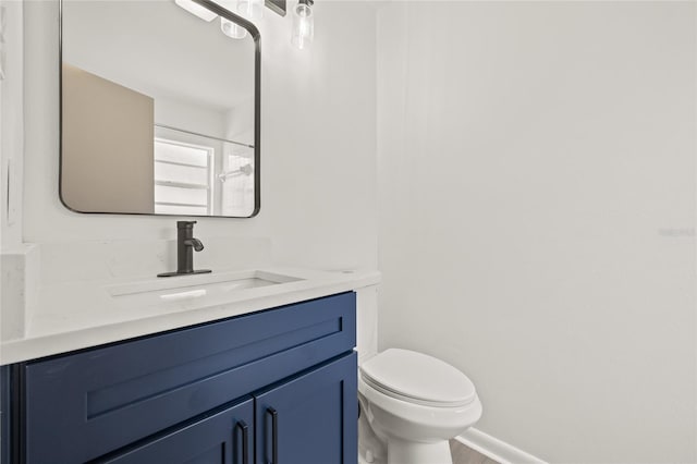 bathroom featuring vanity, toilet, and walk in shower