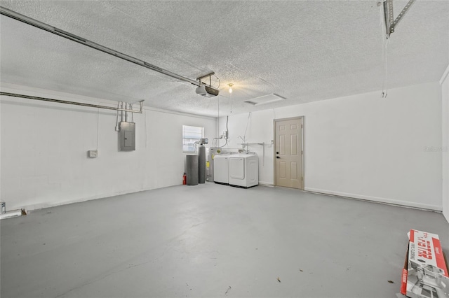 garage with a garage door opener, washing machine and clothes dryer, and electric panel