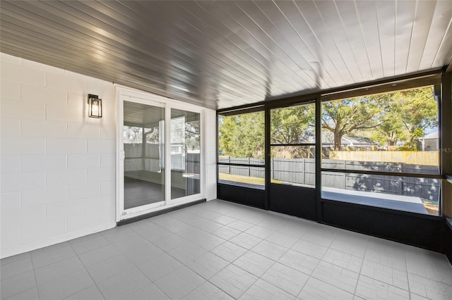 unfurnished sunroom featuring wooden ceiling