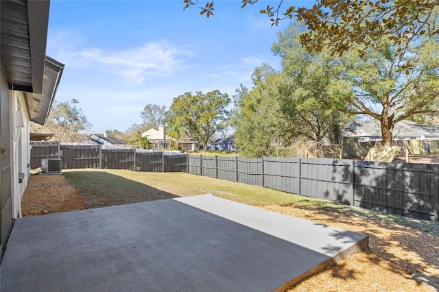 view of yard with central AC unit and a patio area