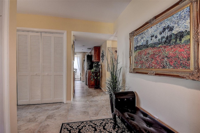 corridor featuring light tile patterned floors