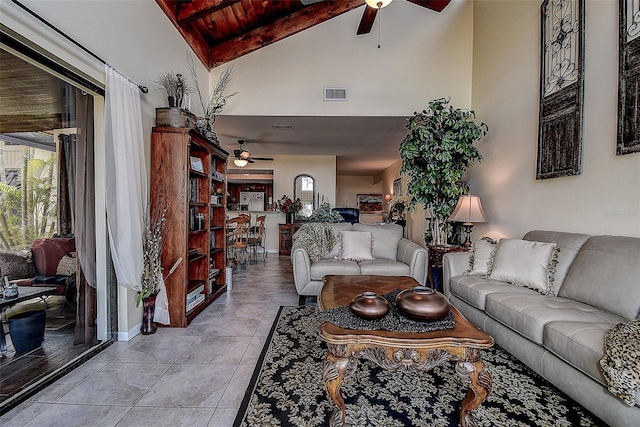 living room with light tile patterned flooring, high vaulted ceiling, a healthy amount of sunlight, and ceiling fan