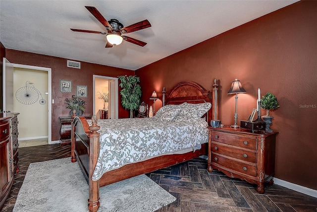 bedroom with ceiling fan and dark parquet floors