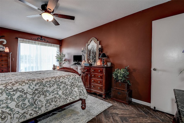 bedroom with ceiling fan and dark parquet floors