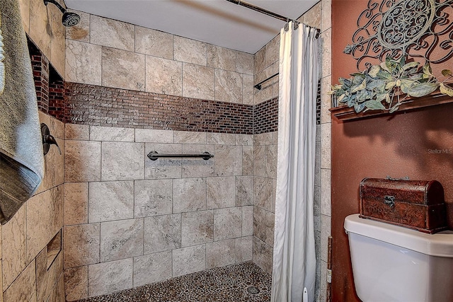 bathroom featuring curtained shower and toilet