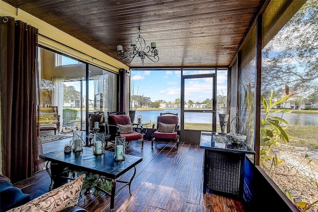 sunroom with a water view, wooden ceiling, and a notable chandelier