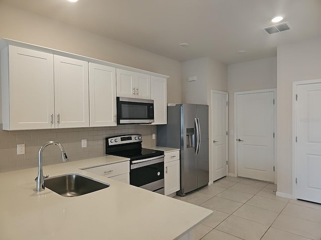 kitchen with stainless steel appliances, sink, and white cabinets