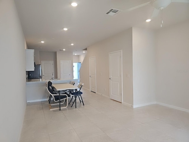 dining area featuring sink and light tile patterned floors