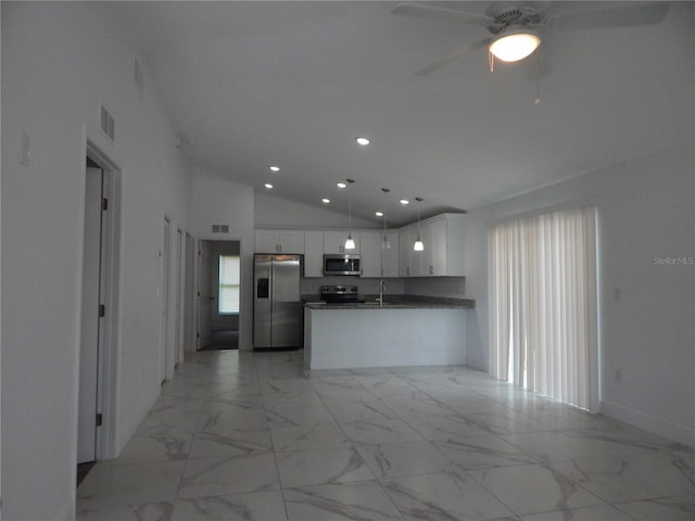 kitchen featuring lofted ceiling, appliances with stainless steel finishes, white cabinetry, hanging light fixtures, and kitchen peninsula