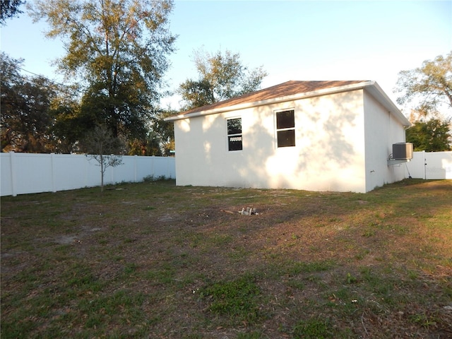 view of side of property with a lawn