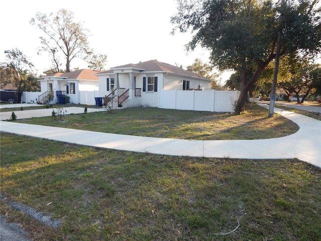 ranch-style home with a front lawn