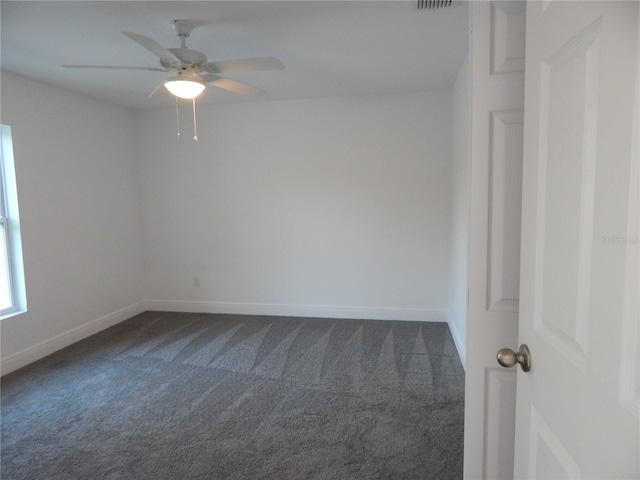 carpeted spare room featuring ceiling fan