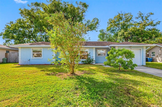 single story home featuring a garage and a front lawn