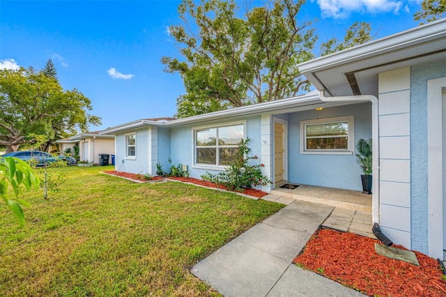 doorway to property with a yard