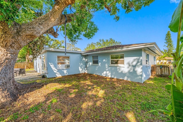 rear view of property with a yard and a patio