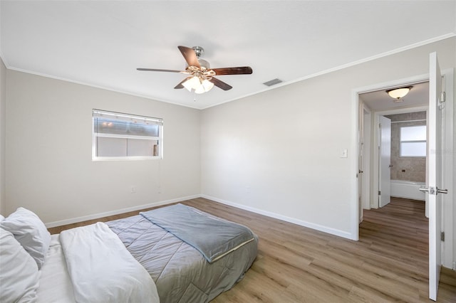 bedroom with wood-type flooring, ornamental molding, and ceiling fan