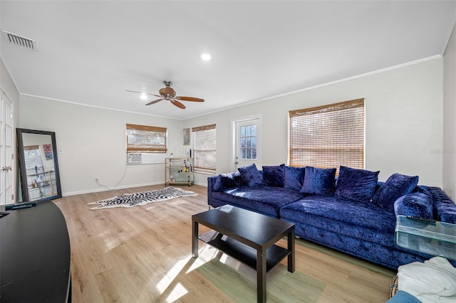 living room with wood-type flooring, ornamental molding, and ceiling fan