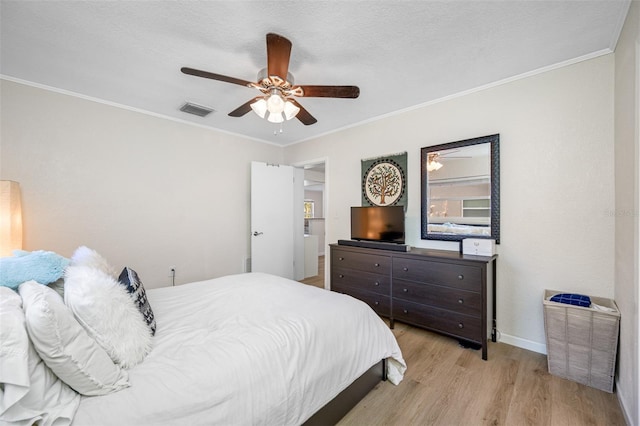 bedroom featuring crown molding, ceiling fan, light hardwood / wood-style floors, and a textured ceiling