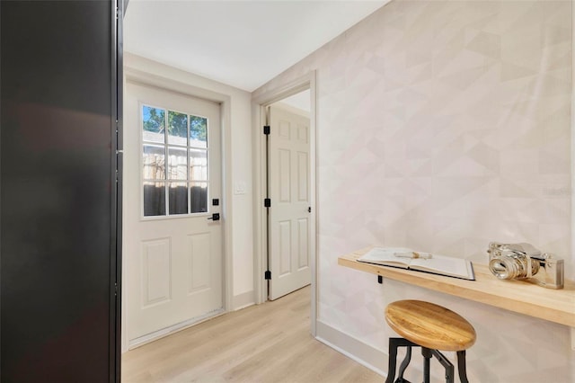 doorway with light wood-type flooring