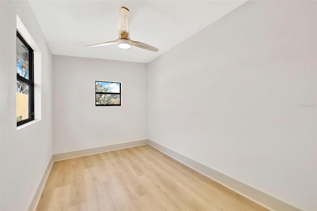 empty room with ceiling fan and light hardwood / wood-style floors