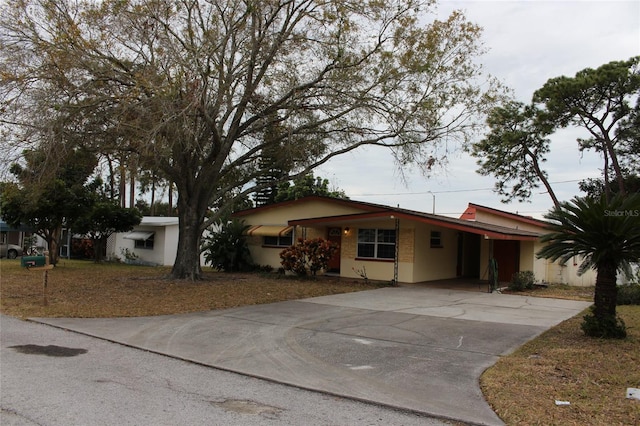 single story home featuring a carport