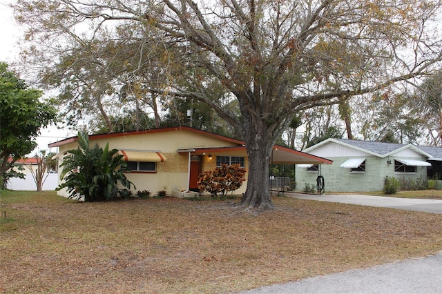 single story home featuring a carport