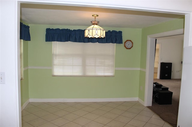 unfurnished dining area featuring tile patterned floors