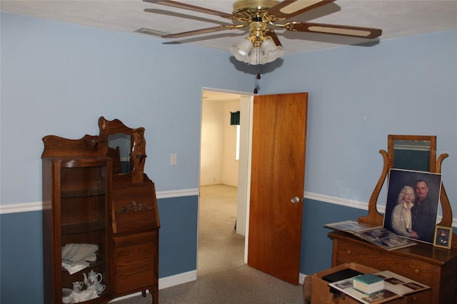 bedroom featuring ceiling fan and carpet