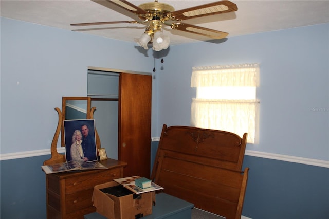 interior space with ceiling fan and a closet