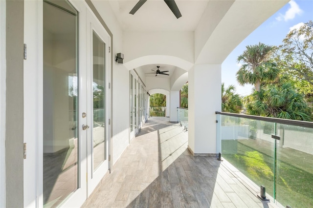 balcony with ceiling fan and french doors