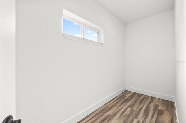 empty room with dark wood-style floors and baseboards