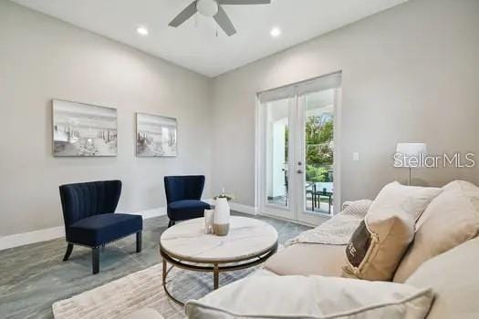 living area featuring french doors and ceiling fan