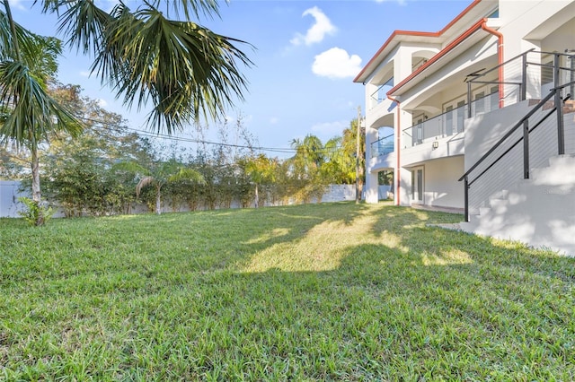 view of yard with a balcony