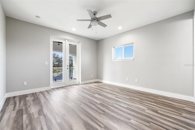 spare room with light hardwood / wood-style flooring, french doors, and ceiling fan