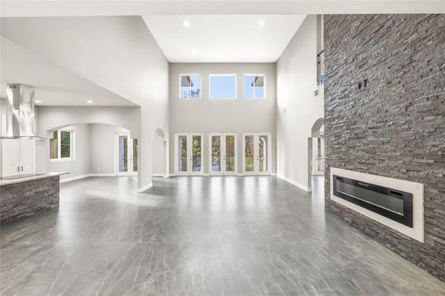 unfurnished living room with a towering ceiling