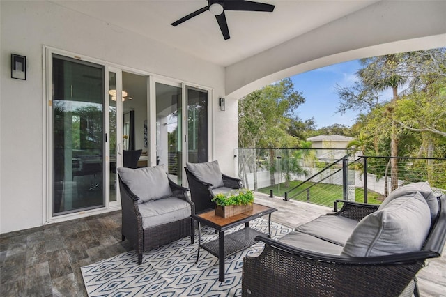 view of patio / terrace with a balcony and a ceiling fan