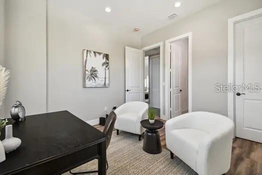 home office with wood-type flooring