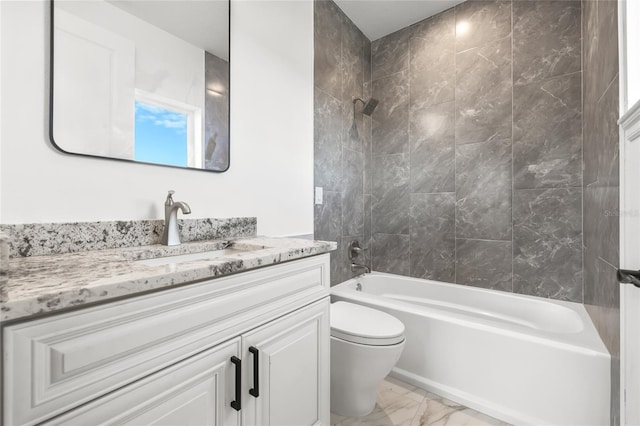 full bathroom featuring tiled shower / bath combo, vanity, and toilet