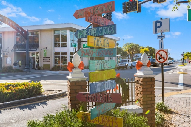 exterior space with sidewalks, traffic lights, traffic signs, and curbs