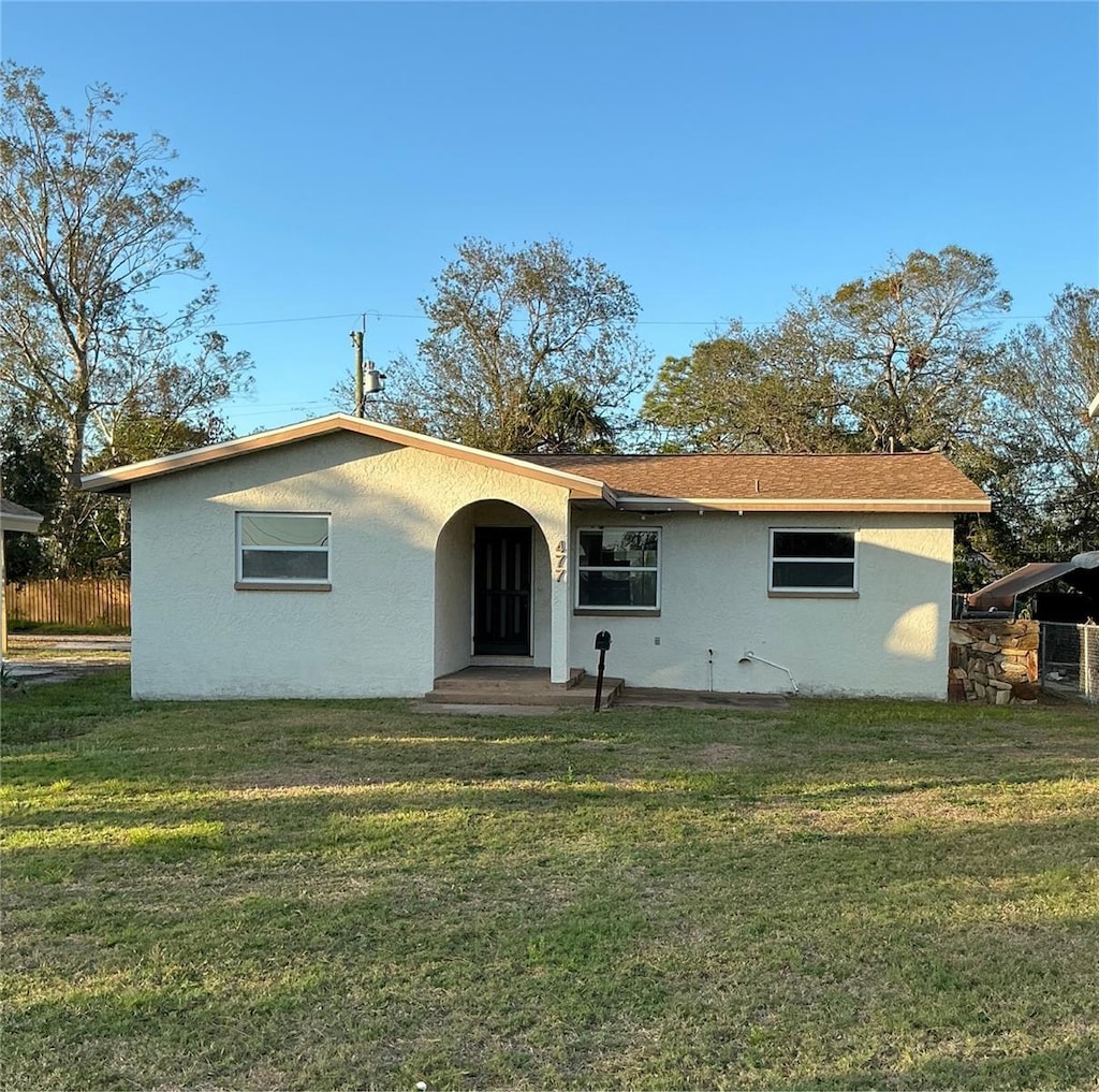 back of property with a yard