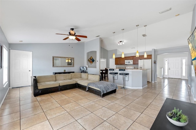 living room with light tile patterned floors, high vaulted ceiling, and ceiling fan