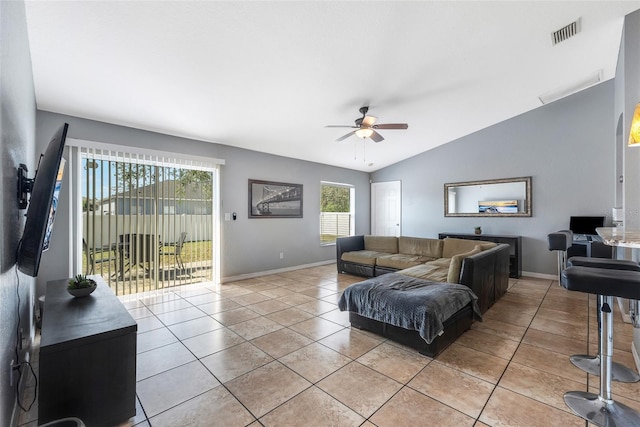 tiled living room featuring lofted ceiling and ceiling fan