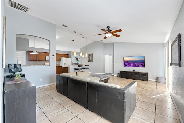 tiled living room featuring lofted ceiling and ceiling fan