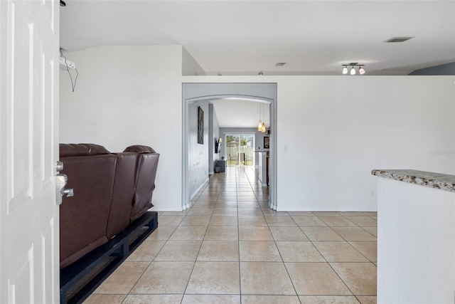 hall featuring light tile patterned floors